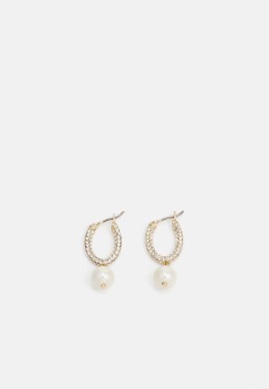 Boucles d'oreilles créoles en or ornées de petits cristaux et chacune présentant une perle blanche unique pendant en bas.