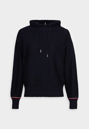 Sweat à capuche noir en tricot à manches longues avec cordons de serrage et poignets côtelés présentant un détail de fine bande rouge et blanche sur chaque poignet.