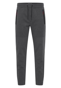 Pantalones deportivos grises con tejido texturizado, que presentan una cintura con cordón y bolsillos laterales con cremallera. Diseño de pierna tapered.