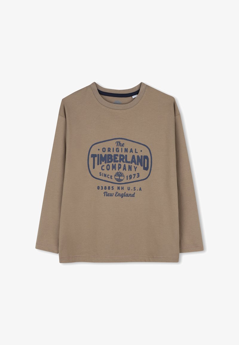 Chemise marron à manches longues avec logo Timberland bleu foncé et texte "The Original Timberland Company Since 1973 New England USA."