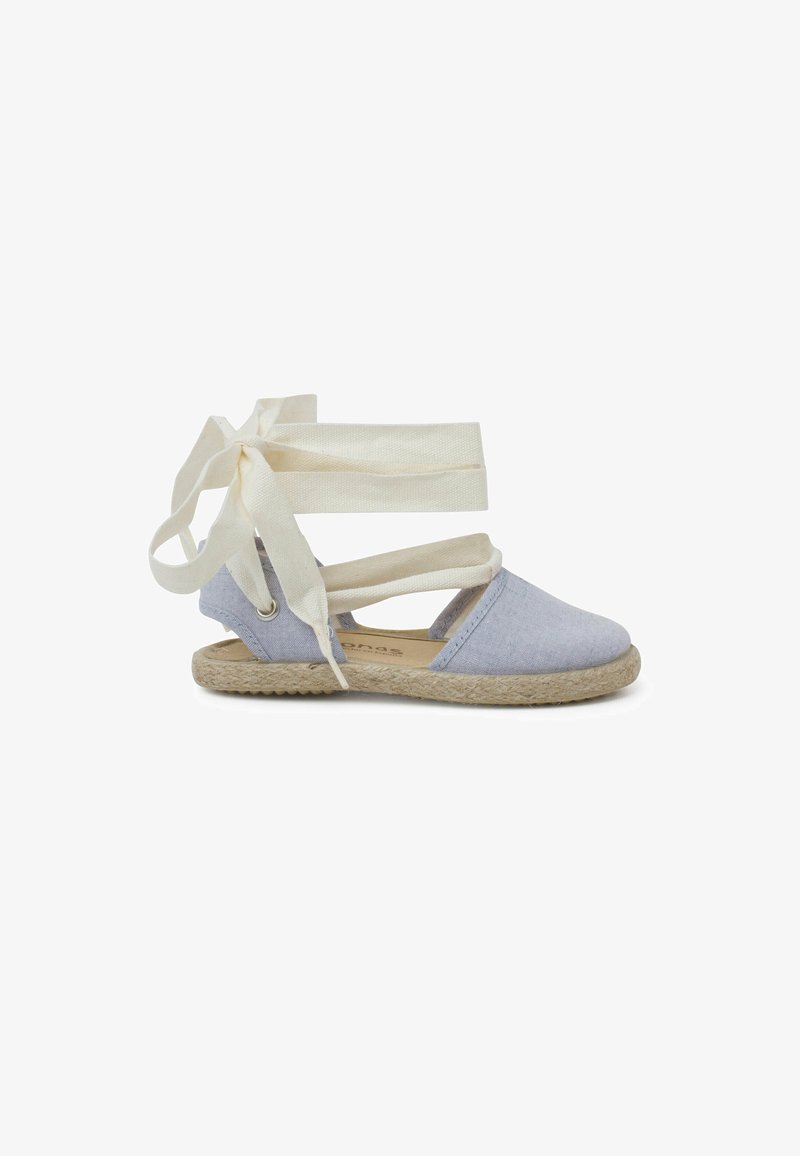 Blue canvas espadrille with cream fabric ties, jute-wrapped sole, round toe, and cut-out sides for breathability.