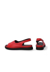 Red leather slingback sandals featuring an open toe, cut-out sides, and a black rubber sole. Detailed with a cushioned insole for comfort.
