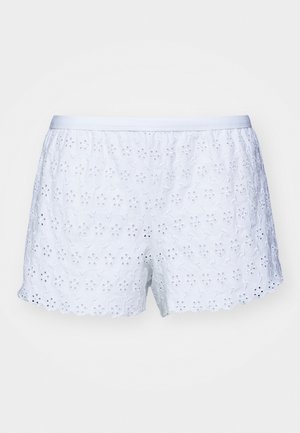 Hvite bomullsshorts med blomstermønster i øyelet, bølgekant og elastisk midje. Lett tekstur som passer for varmt vær.