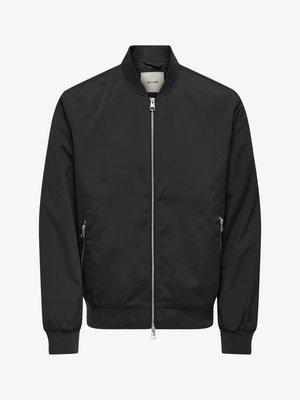 Svart bomberjakke med hel sølvglidelås foran, to glidelåslommer på sidene, ribbestrikkede mansjetter, krage og midjebånd.