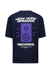 Navy blue t-shirt featuring a large purple speaker graphic with the text "NEW YORK GROOVE RECORDS" and tagline below in white. Soft cotton material.