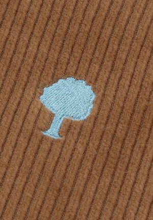 Icona di albero ricamata blu chiaro su sfondo di tessuto marrone a coste.