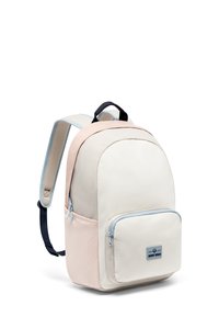 Teherszállító hátizsák, amelynek krémszíne van, puha rózsaszín kiegészítőkkel, kék cipzár részletekkel, szövet anyagból készült, és egy elülső zseb, amelyen logó folt található.