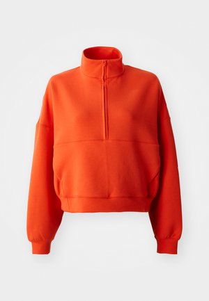 Felpa cropped arancione brillante con collo alto e mezza zip, caratterizzata da maniche larghe e un tessuto testurizzato per il massimo comfort.