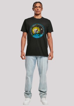 Black cotton t-shirt featuring a circular NASA-themed graphic with vibrant colors, depicting an astronaut and stars, paired with light blue jeans.