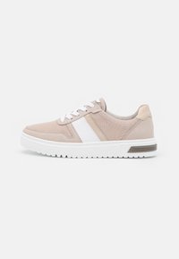 Beige sneaker with white accents, fabric and synthetic materials, lace-up design, textured sides, and a white rubber sole with tread.