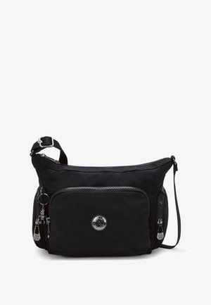 Black nylon shoulder bag with a zippered front pocket, silver hardware, curved design, and adjustable strap. Features logo and decorative keychain.
