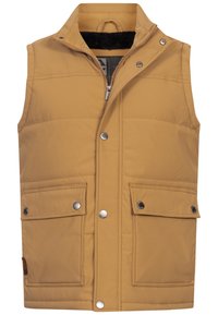 Chaleco sin mangas acolchado en color marrón claro, con cremallera frontal, botones a presión, dos bolsillos con solapa y cuello forrado de forro polar.