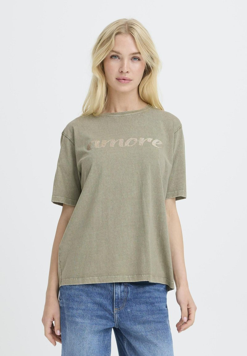 Camiseta corta de algodón color verde oliva, con mangas cortas, que presenta "amore" en un estampado metálico claro en el pecho y un corte holgado.