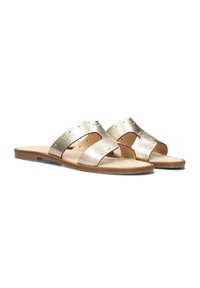 Metallic gold slide sandals with two wide crossover straps, textured surface, and small decorative studs on the straps. Flat wooden sole.