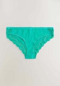 Culottes vertes en mélange de coton avec accents en dentelle sur les côtés, bords festonnés et finition lisse.