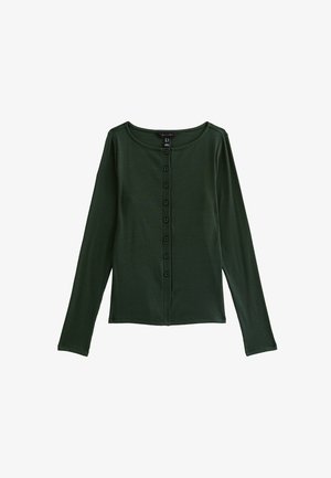 Top lungo a maniche nelle tonalità di verde scuro con scollatura rotonda e chiusura a bottoni, realizzato in tessuto a costine, con sei bottoni centrali.