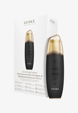 Microdermabrasion compacte microcourant noire et dorée avec capuchon de protection, présentée à côté d'une boîte blanche avec texte de marque et caractéristiques.