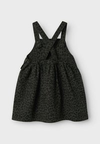 Schwarz gepunktetes Kleid mit überkreuzten Trägern, Knopfakzenten und einem gerafften Rockdesign. Aus strukturiertem Stoff gefertigt.