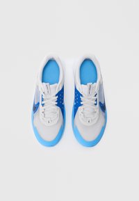 Laced athletic shoes featuring a gray upper, blue overlays, mesh fabric, padded collars, and a prominent logo on the sides.