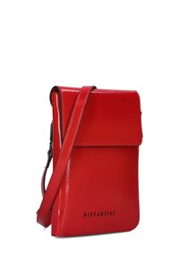 Red, glossy crossbody bag with a flap closure, adjustable strap, and embossed "HISPANITAS" branding on the front. Smooth texture, rectangular shape.