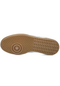 Witte sneakerzool met een gestructureerde bruine rubberen loopzool, voorzien van een ronde embleem met "37" en een patroon van gripdesign.