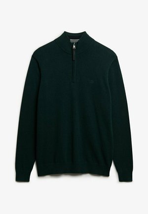 Pull vert foncé à manches longues avec un col haut côtelé et une fermeture éclair sur le devant sur un quart, en tissu tricoté.