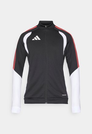 Czarna sportowa kurtka z czerwonymi i białymi akcentami, zapinana na zamek z przodu, z wysokim kołnierzem i logo w postaci trzech białych pasków na piersi. Elastyczna tkanina.