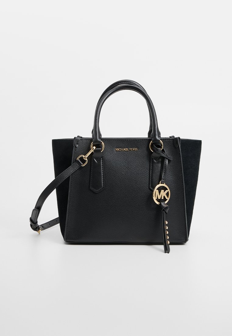 Borsa nera con texture in pelle e camoscio, dotata di doppio manico, cintura regolabile, finiture in oro e un'etichetta con il logo MK sospesa.