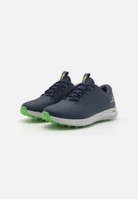 Pantofi de golf cu un upper sintetic de culoare albastru marin, speri din cauciuc de culoare verde și un design texturat. Au șireturi și o talpă cu amortizare de culoare albă.