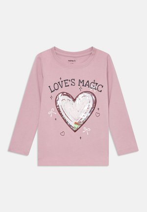 Langarm-Pinkshirt mit glitzerndem Herzdesign und dem Text "LOVE'S MAGIC", umgeben von kleinen Herzen und Schleifen. Aus Baumwolle gefertigt.
