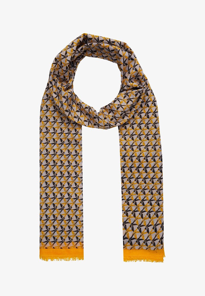 Écharpe longue avec motif géométrique d’oiseaux jaunes, noirs et blancs, extrémités à franges jaunes, enroulée en haut, sur fond blanc.