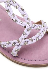 Sandalia plana lila con tiras trenzadas que cuentan con cristales incrustados. Plantilla de suave ante y suela texturizada para mayor agarre.