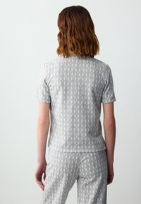 Grijs patronen T-shirt met korte mouwen en een geometrisch ontwerp in lichtblauw en beige, gemaakt van zachte stof, met een losse pasvorm en een ronde halslijn.