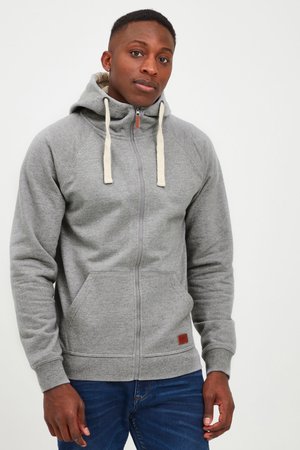 Grijze zip-up hoodie met een snug fit, capuchon met trekkoord, voorkeepockets en geribde manchetten. Zachte textuur met een subtiel heatherpatroon.