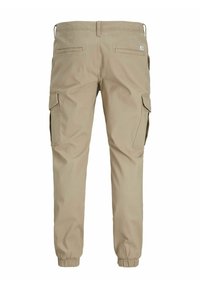Beige cargo pants with an elastic waistband, two side pockets, and two cargo pockets on thighs. Smooth fabric with tapered cuffs.