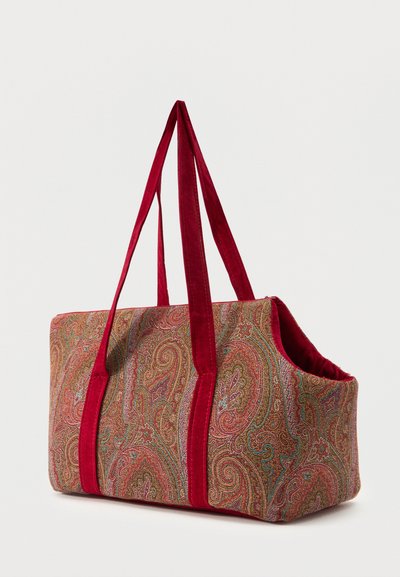 Large tote bag with red velvet handles and sides, featuring a detailed paisley pattern in red, gold, and blue tones on fabric body.