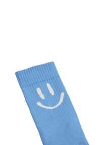 Világoskék pamut zokni bordás szegéllyel, fehér mosolygós arc mintával az alsó részén.