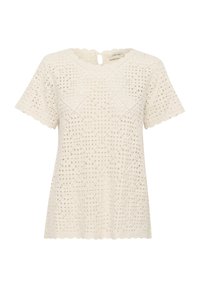 Top in pizzo crema con scollatura a onda, maniche corte e intricati ritagli a forma di diamante su tutto il tessuto. Dettaglio con apertura a chiave sul retro.