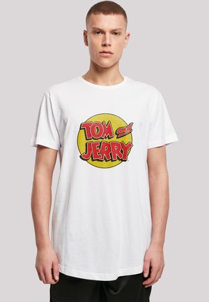 White cotton t-shirt featuring a circular, multicolored "Tom and Jerry" graphic in red and yellow with bold, playful lettering.