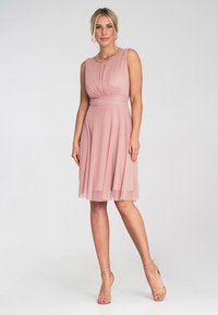 Różowa sukienka bez rękawów z plisowanym dołem, dopasowanym w pasie i gładkim materiałem. Posiada okrągły dekolt oraz subtelne marszczenia w okolicy biustu.