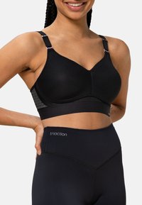 Schwarzer Sport-BH mit strukturiertem Mesh-Design. Verfügt über verstellbare Träger mit einem rosa Akzent und ein glattes Unterband.
