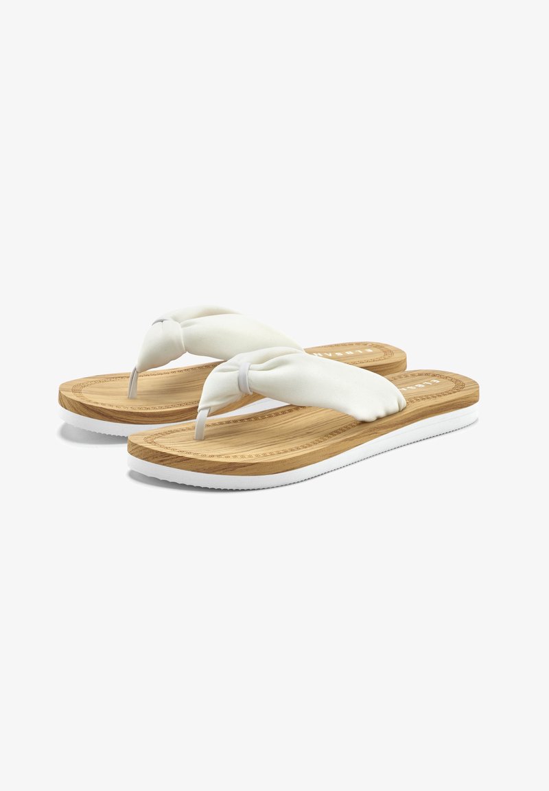 White flip-flops with soft fabric straps and a natural bamboo-textured sole. The sole features a white rubber outsole for grip.