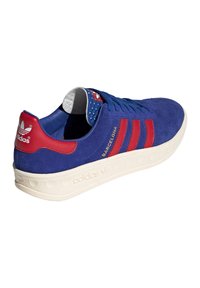Blue suede Adidas Barcelona sneaker with red stripes, red heel tab, and white sole, angled showing right side and back.