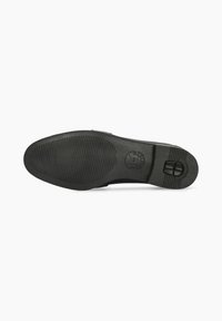 Semelle de chaussure noire en caoutchouc avec des motifs de texture antidérapants, forme arrondie, et un détail en logo circulaire. Fini lisse avec un profil plat.