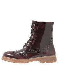 Botas de tobillo de cuero marrón con un acabado brillante, detalles de brogue, diseño con cordones y una suela de goma texturizada.
