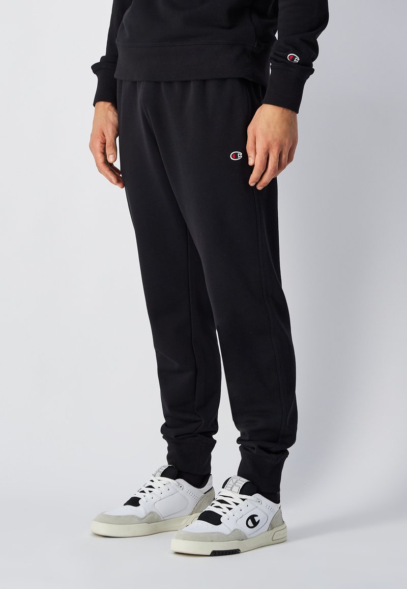 Sorte sweatpants lavet af en bomuldsblanding, med en tapered fit, elastisk talje og sidelommer. Accentueret med et lille broderet logo.