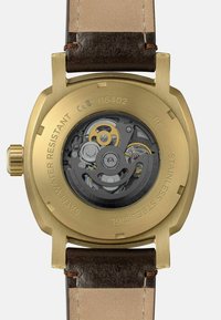 Retro della watch automatico dorato con ingranaggi visibili, cinturino in pelle marrone e incisioni che indicano resistenza all'acqua e acciaio inossidabile.