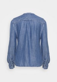 Camicia di jeans azzurro chiaro con maniche lunghe, tessuto testurizzato, scollatura raccolta e polsini elasticizzati. Presenta una vestibilità morbida e un dettaglio di piega posteriore.