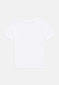 T-shirt en coton blanc à manches courtes, col rond et ourlets de manches repliés. Conception simple sans graphiques ni motifs.