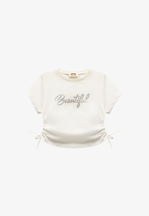 Weißes T-Shirt mit kurzen Ärmeln, auf dem "Beautiful" in Strass gedruckt ist. Verfügt über verstellbare Seitenschlaufen und einen runden Halsausschnitt. Aus softem Baumwollmaterial.
